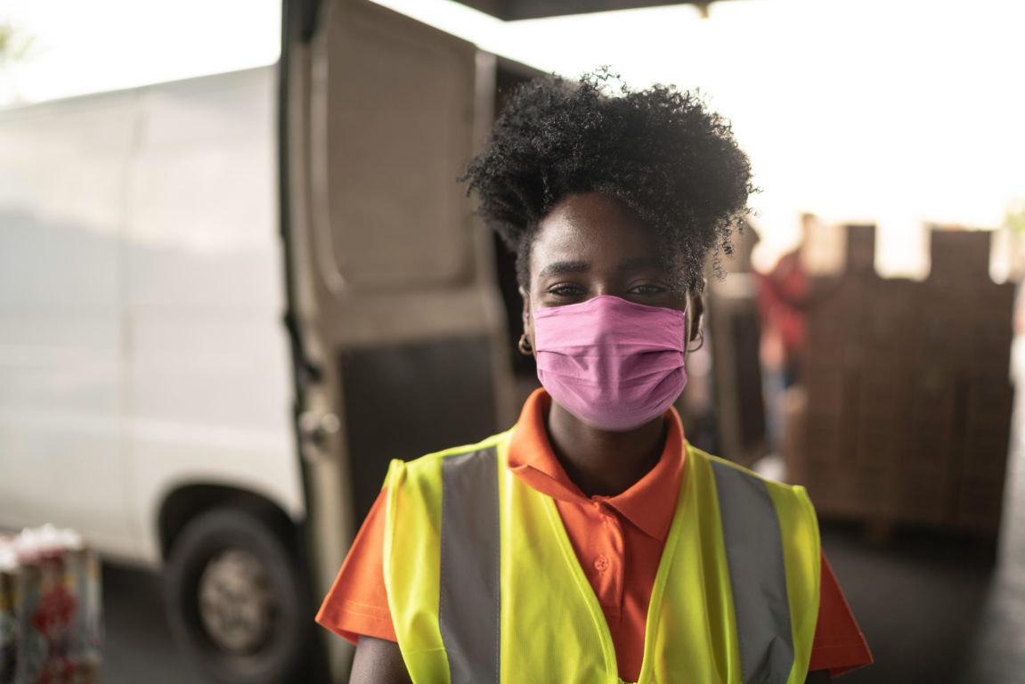 African young woman portrait at warehouse with face mask