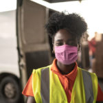 African young woman portrait at warehouse with face mask