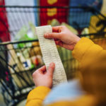 A person checking their bill in a grocery store