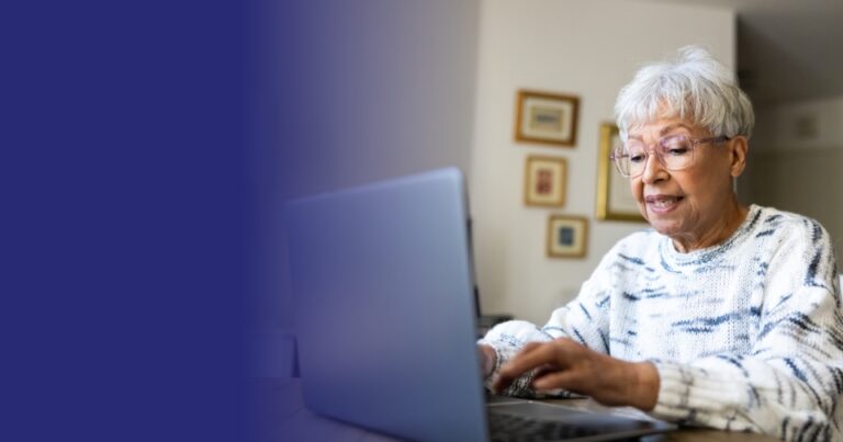 Older adult using a laptop at home