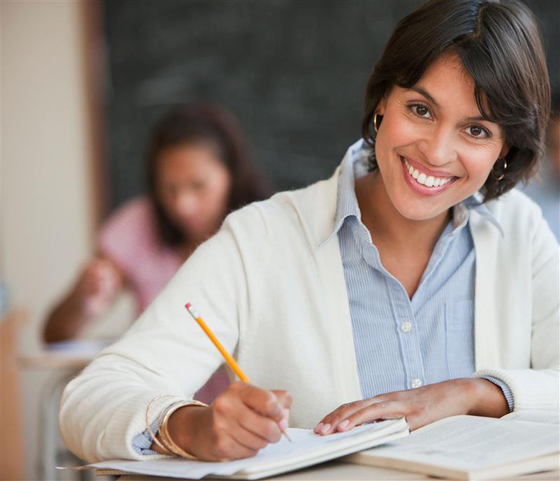 Photo of person writing in a class